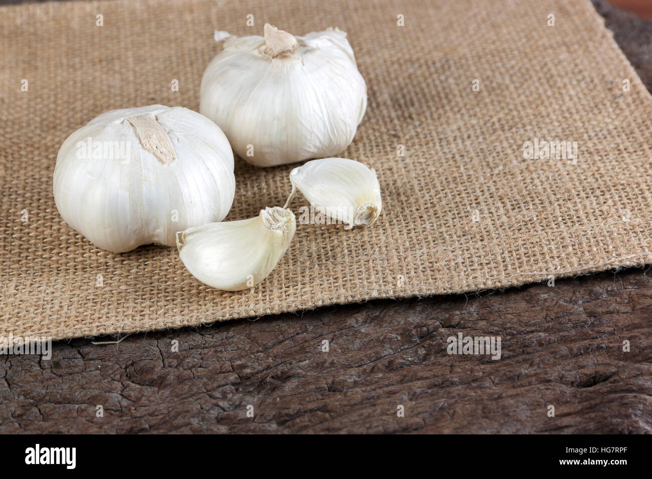 Garlic cloves on a vintage wooden background Stock Photo - Alamy
