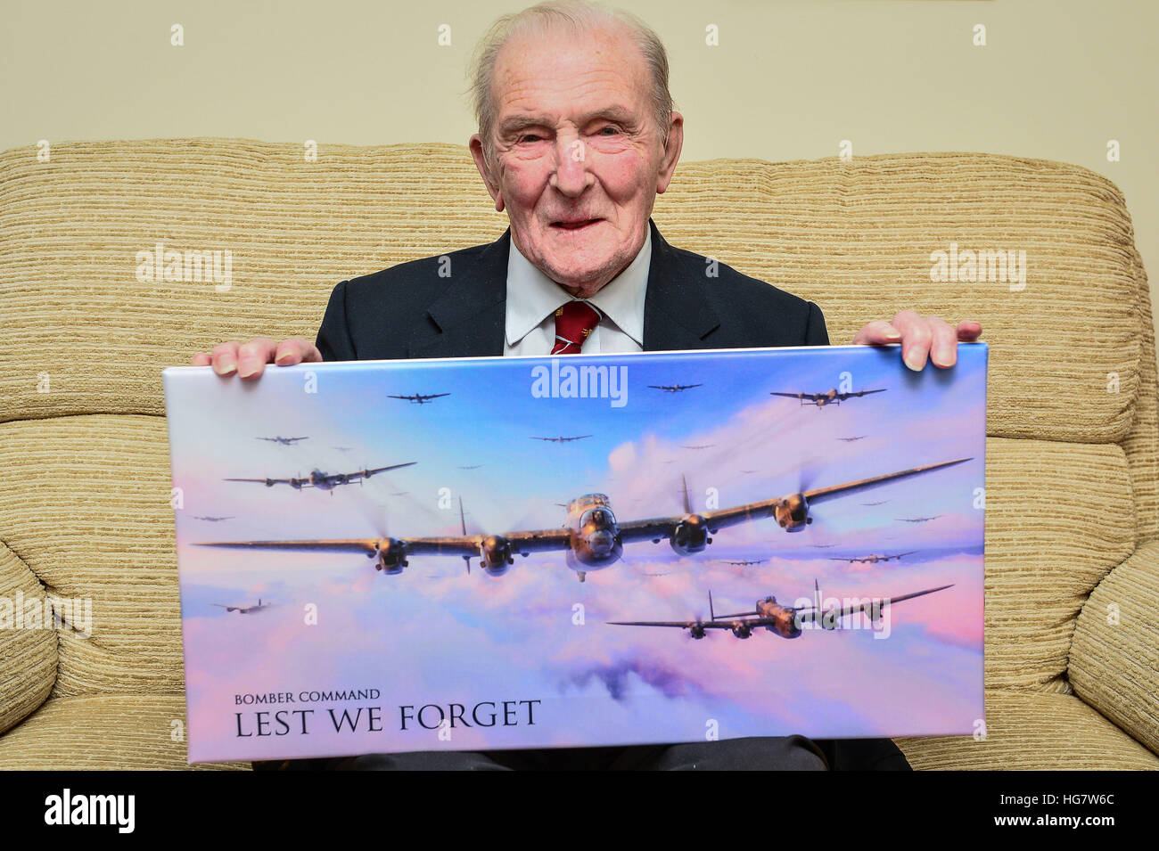 George 'Johnny' Johnson, 95, holds a picture of Lancaster bombers at his home in Bristol, as the last surviving British Dambuster has said that if he received a knighthood it would be to remember his squadron and not himself. Stock Photo