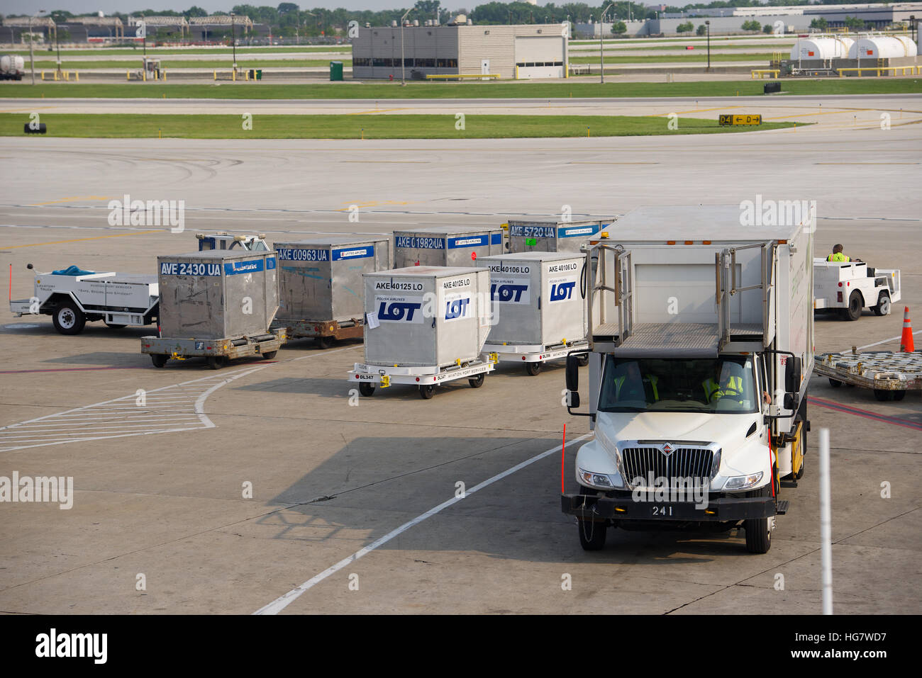 Truck and cargo handlers at Chicago O'Hare International Airport, Illinois, USA. Stock Photo