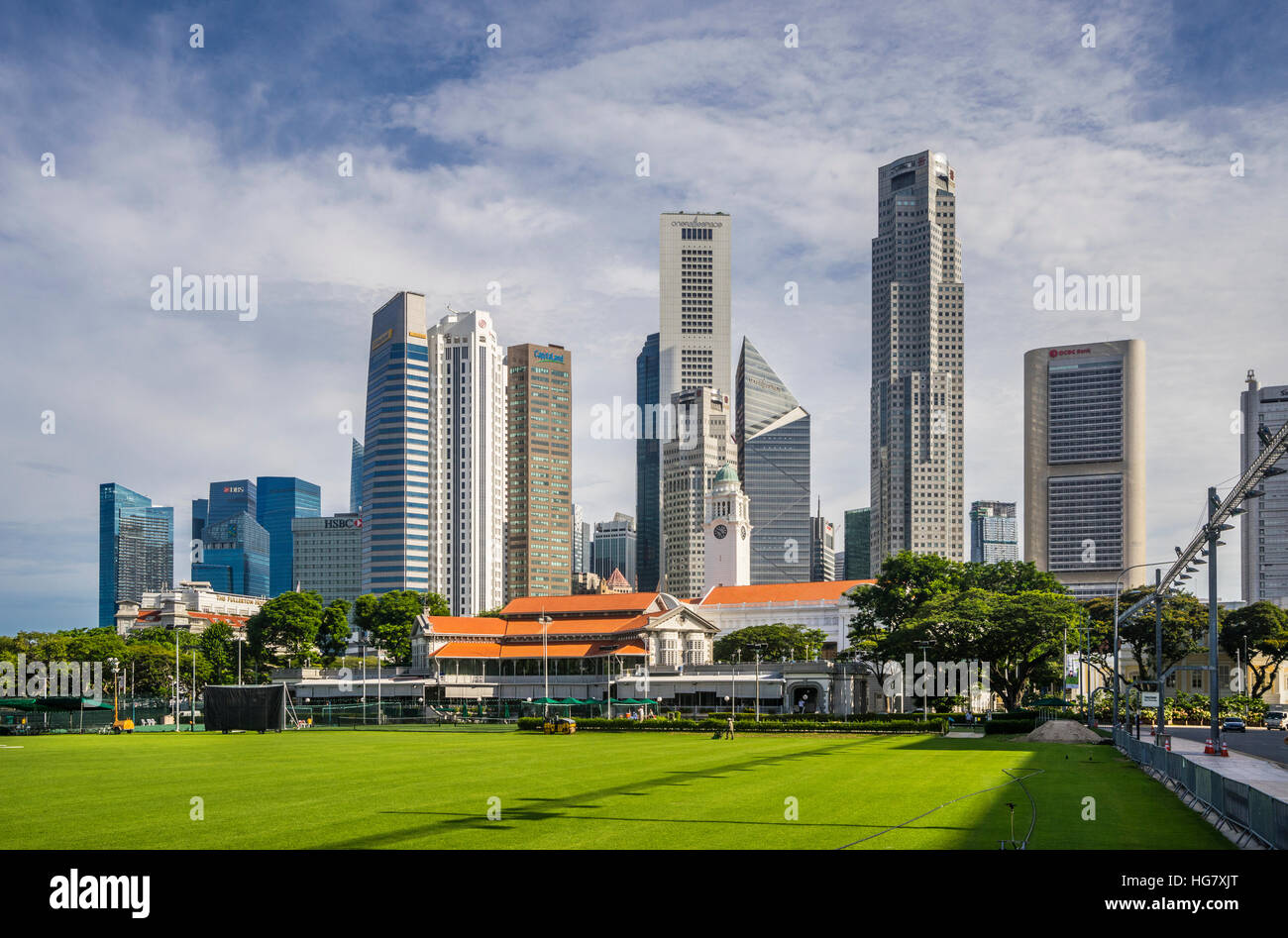 view of the Singapore skyline across the Padang open playing field with Singapore Recreation Club building Stock Photo
