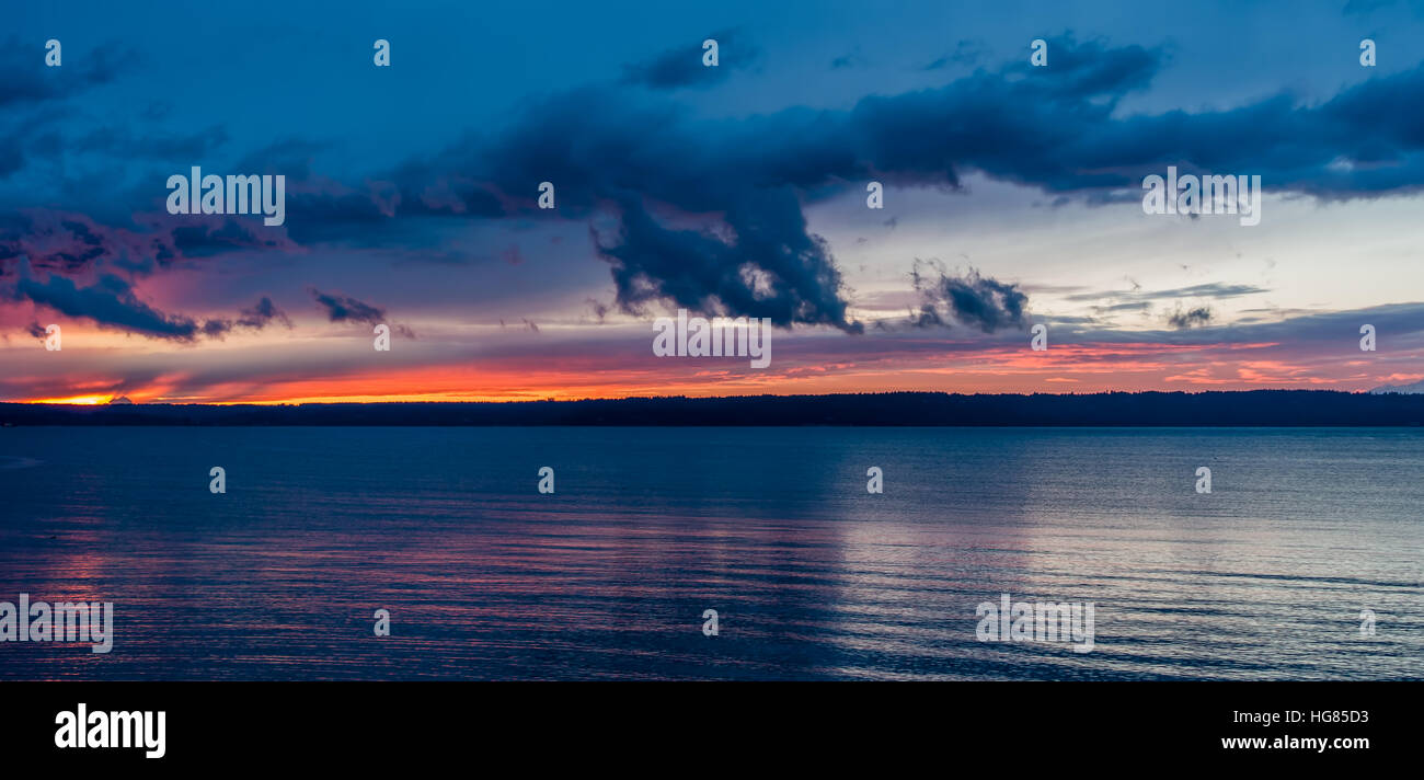 The sun sets behind the Puget Sound in winter. Stock Photo