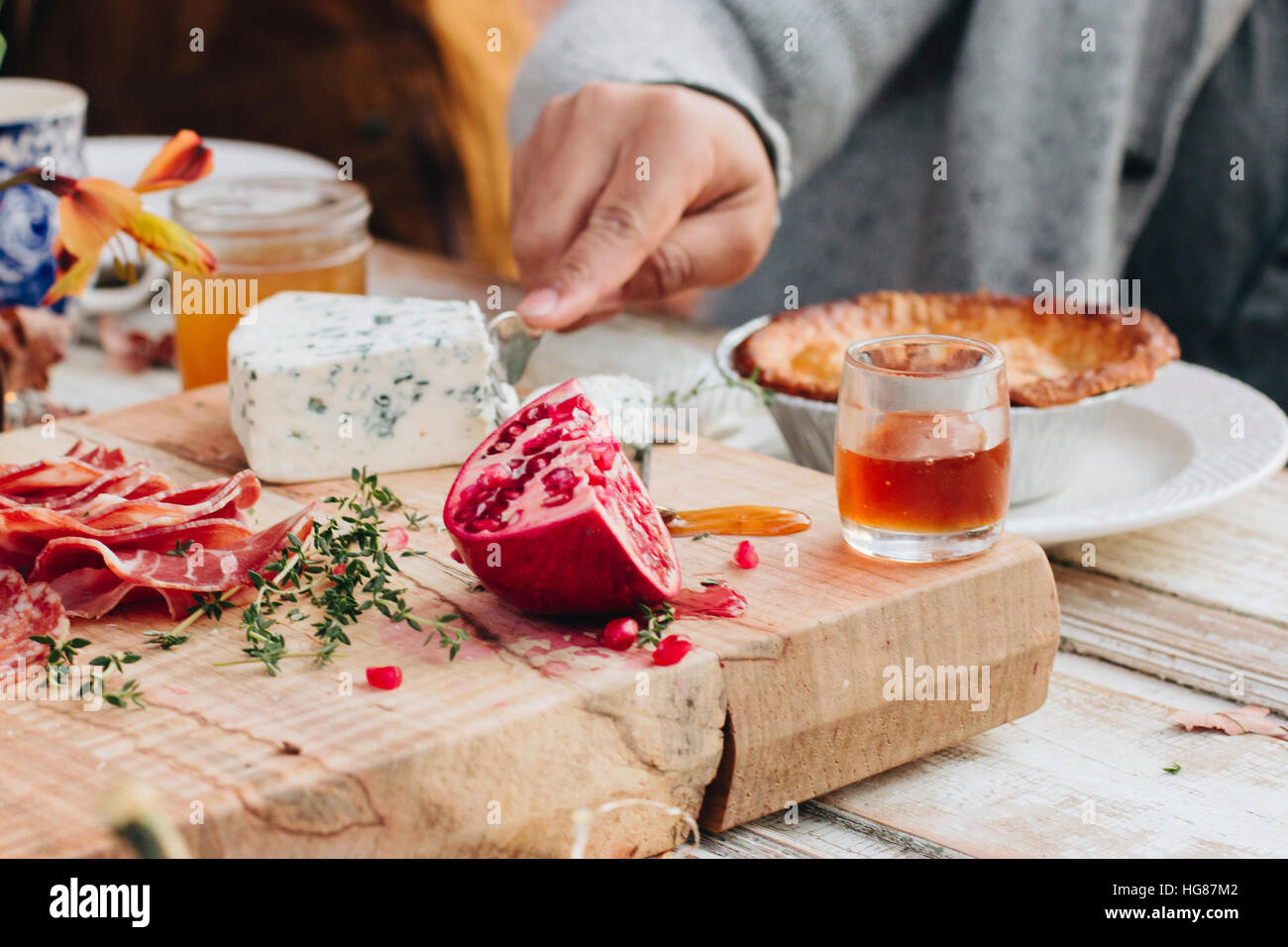 Cropped image of hand cutting cheese Stock Photo
