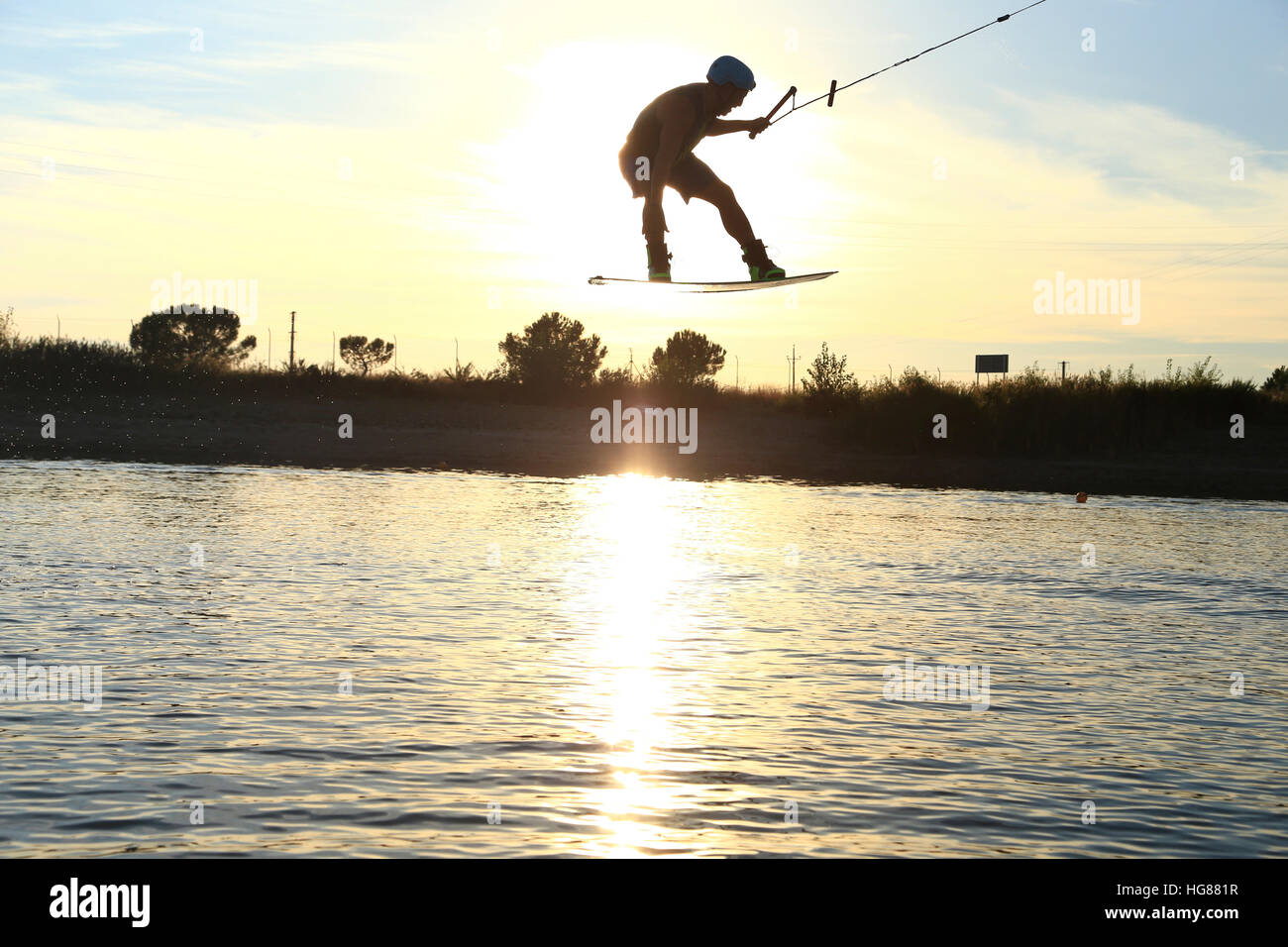Man kiteboarding over lake against sky Stock Photo