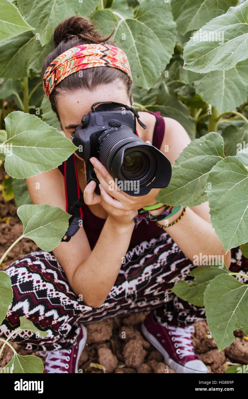Young woman taking photographies in nature Stock Photo - Alamy