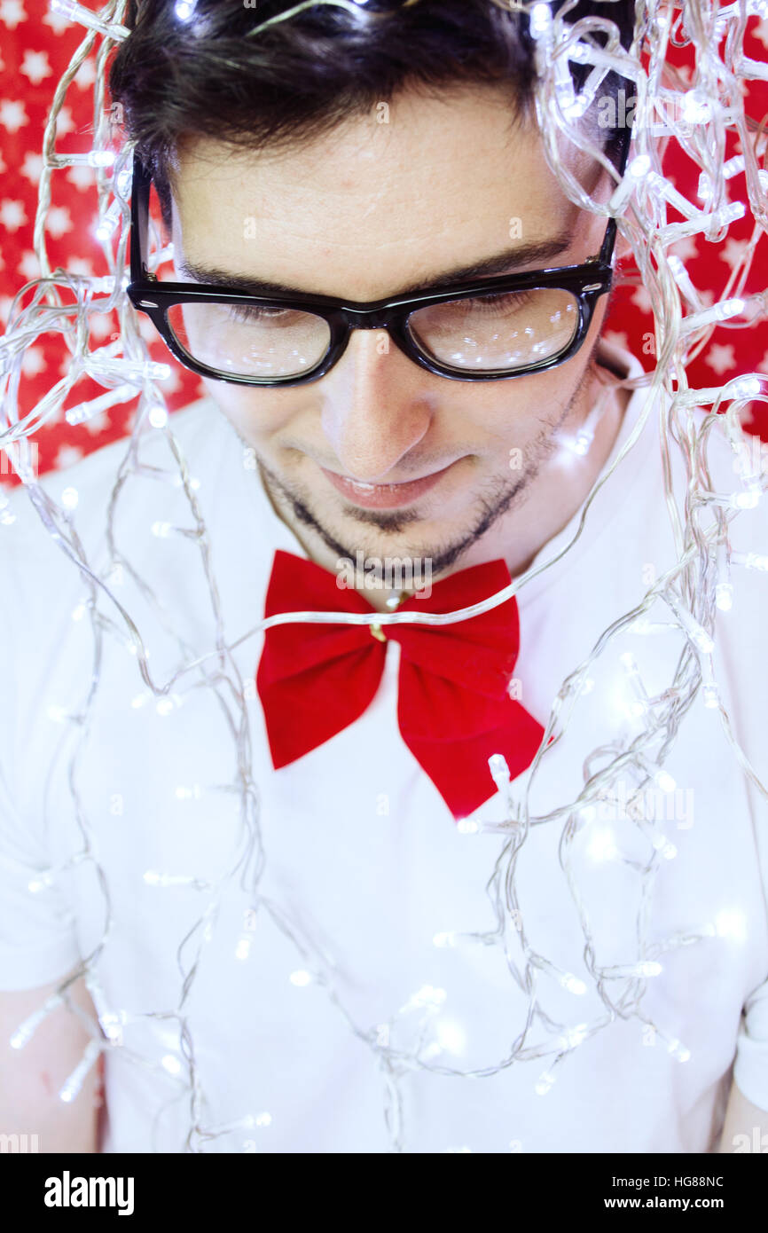 Young man wearing christmas lights Stock Photo Alamy