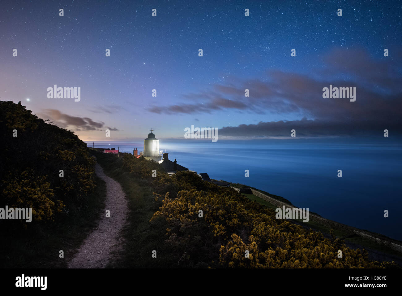 Whitby Lighthouse under a star lit night on the East Yorkshire Coast Stock Photo