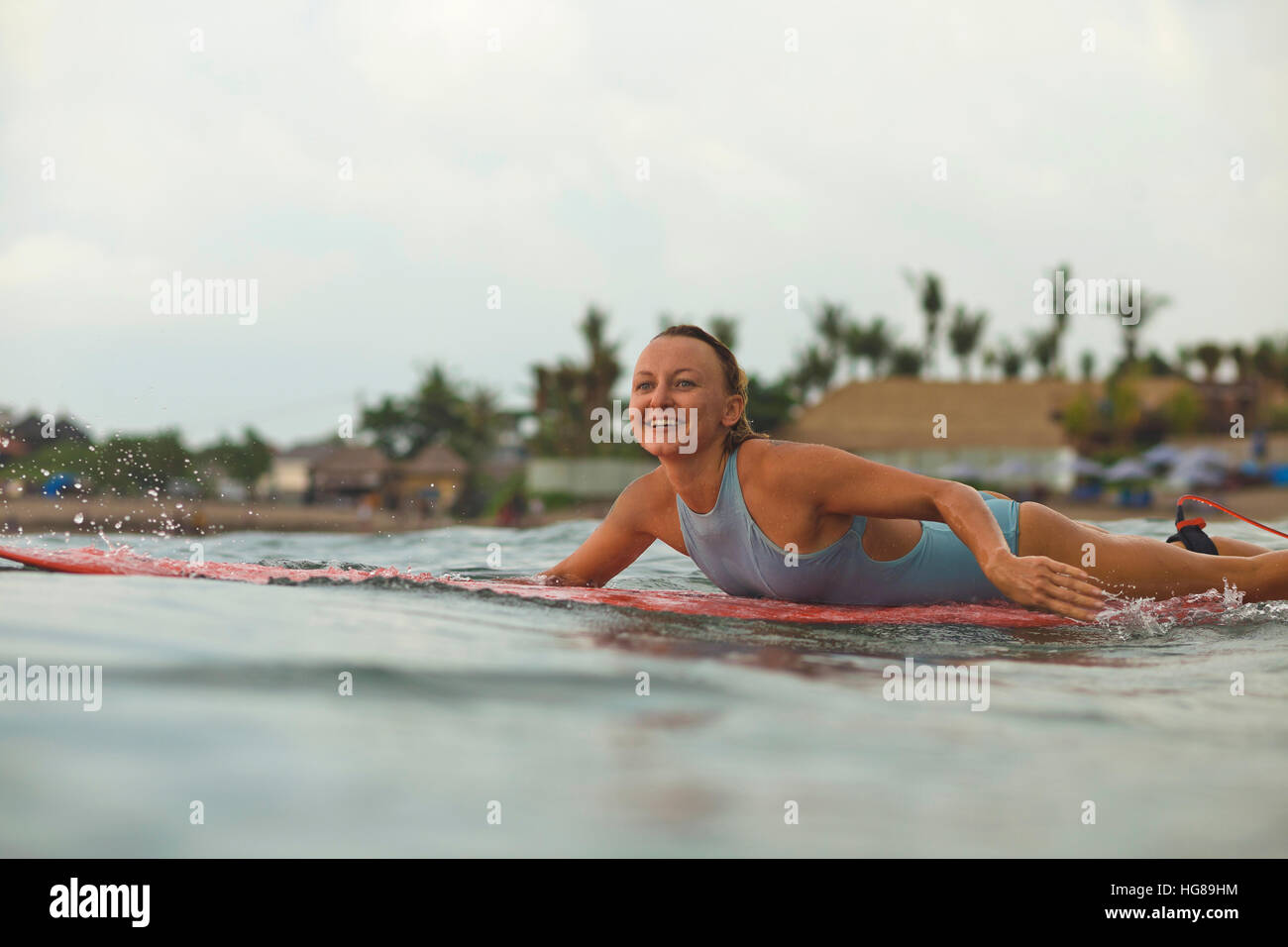 Woman Lying On Surfboard In Stock Photos & Woman Lying On Surfboard In