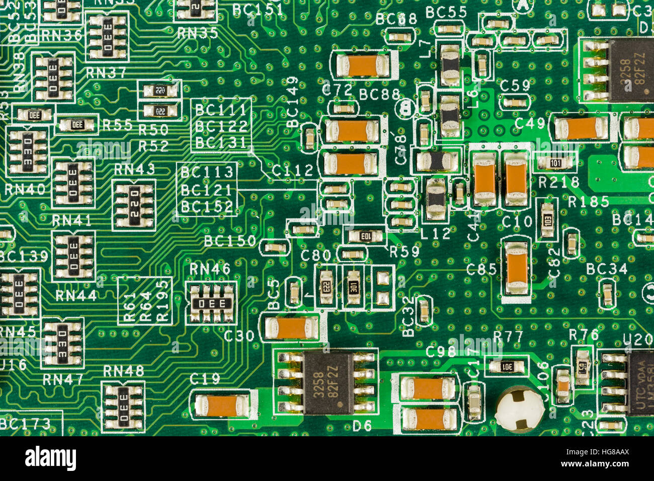 Green circuit board with conductive tracks and elements Stock Photo - Alamy
