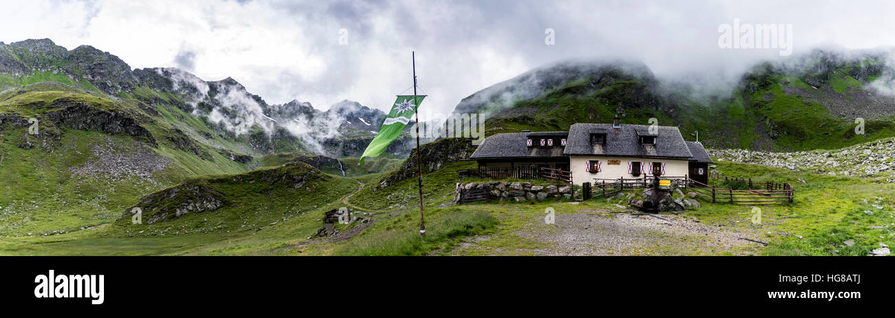 Landawirseehütte and Alpine Club flag with cloudy Alpine valley, Rohrmoos-Untertal, Schladming, Schladming Tauern, Styria Stock Photo