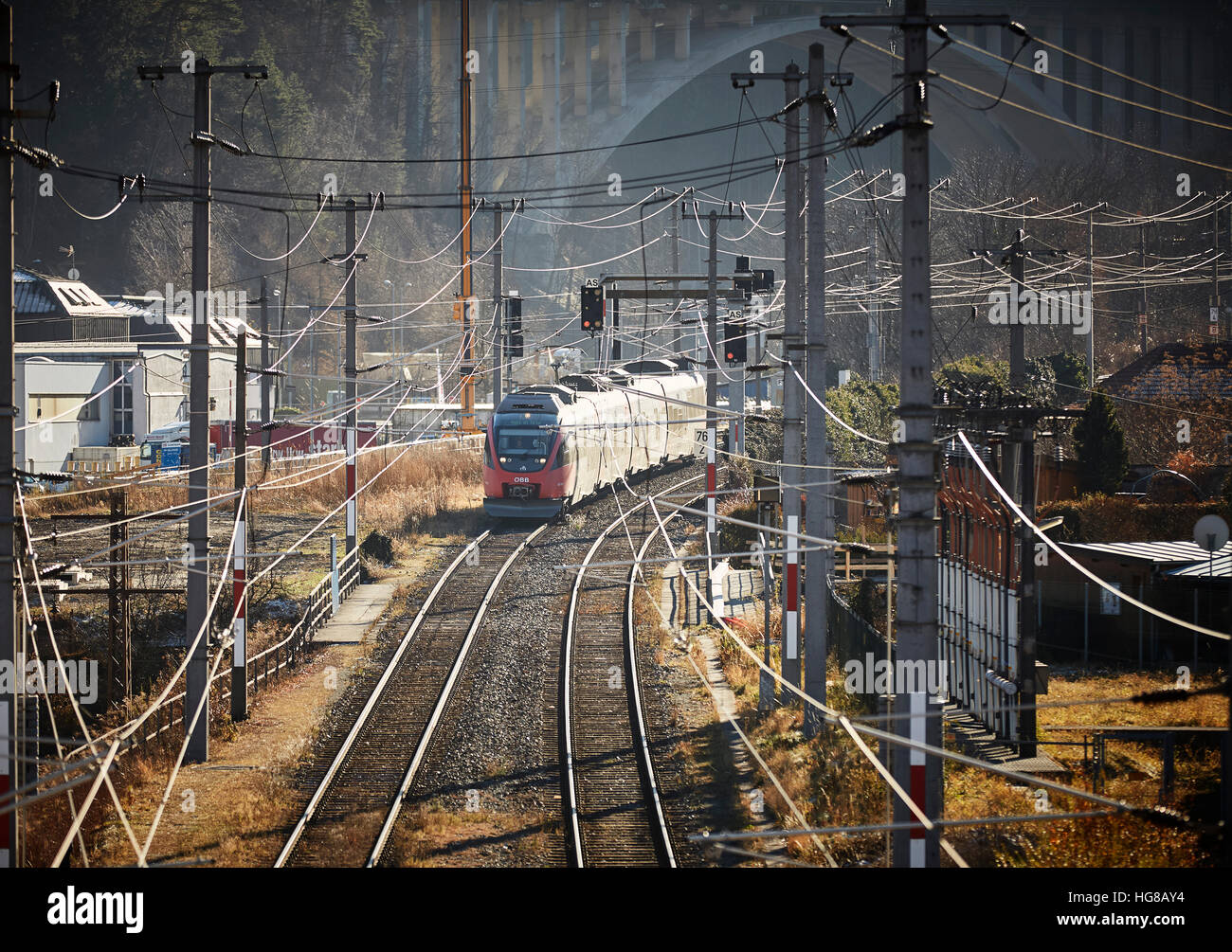 Overhead wires, train track with passenger train, Innsbruck, Tyrol, Austria Stock Photo