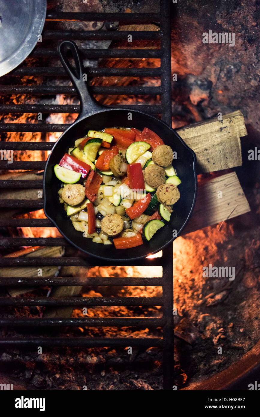 Overhead View Of Food Cooking In Pan Over Fire Pit Stock Photo