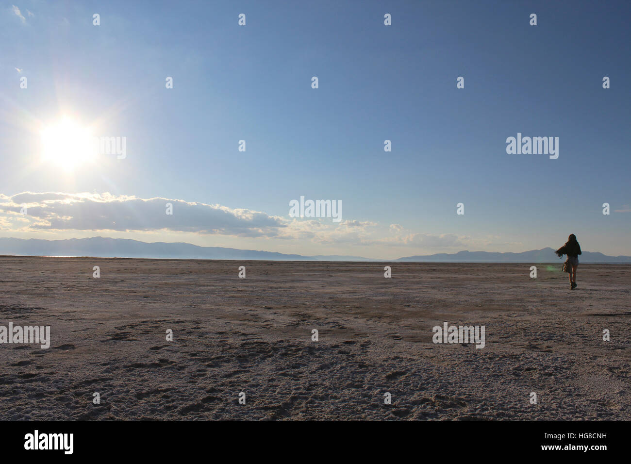 Rear view of woman walking on landscape Stock Photo - Alamy