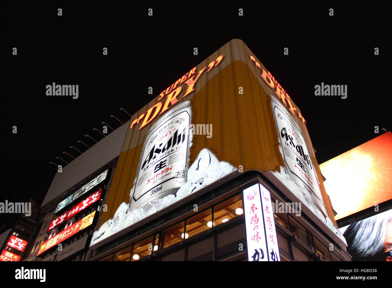 Billboards tower over shops and restaurants in Osaka, Japan Stock Photo