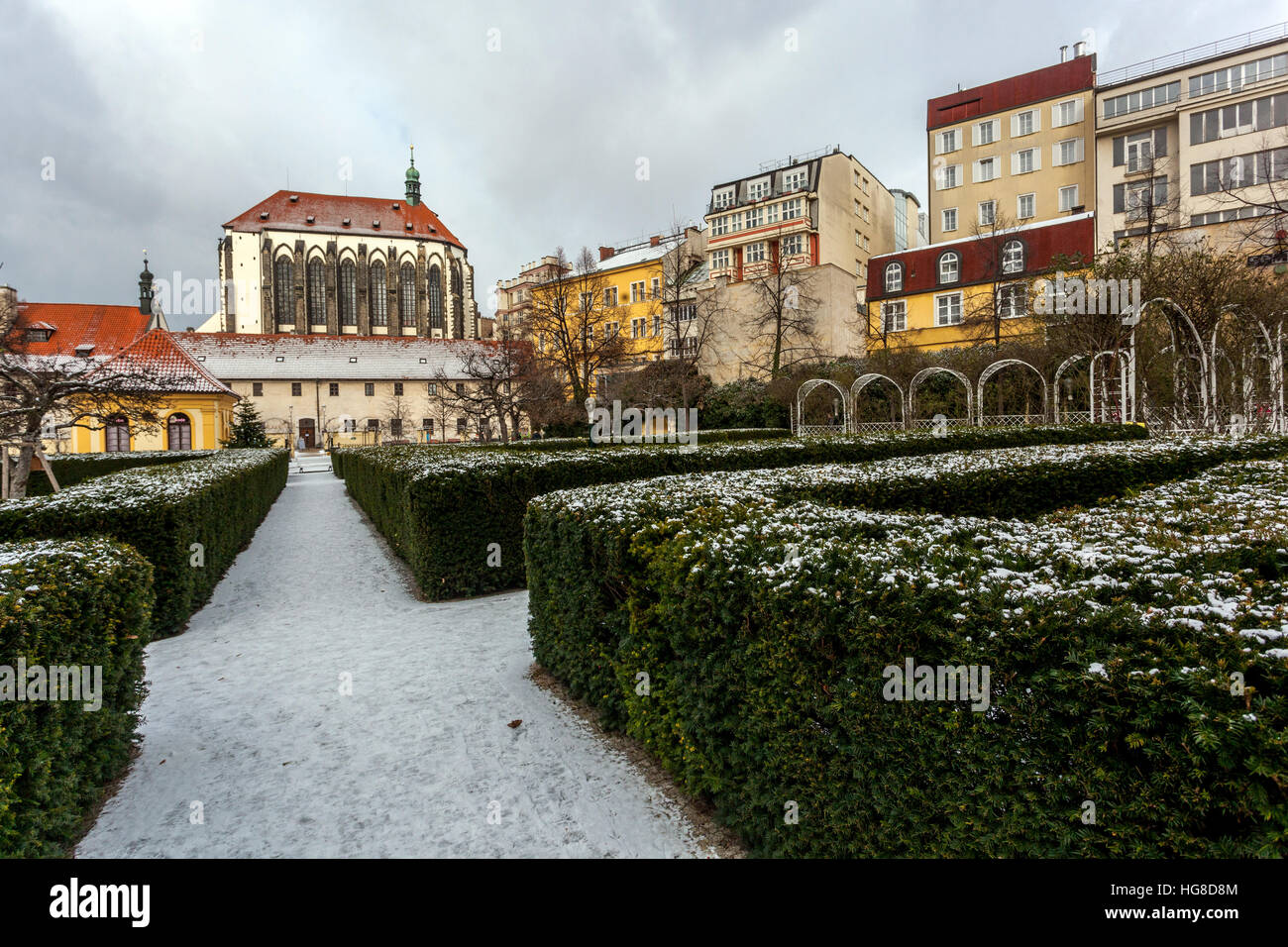 Prague Franciscan Garden near Wenceslas Square in the background Church of Our Lady of the Snows, Prague, Czech Republic Old Urban Garden hedge snow Stock Photo