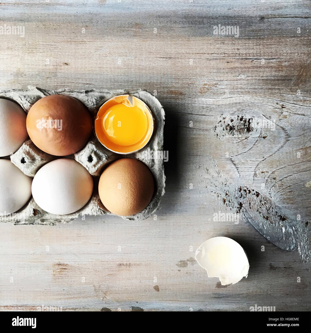 Overhead view of eggs in tray on table Stock Photo