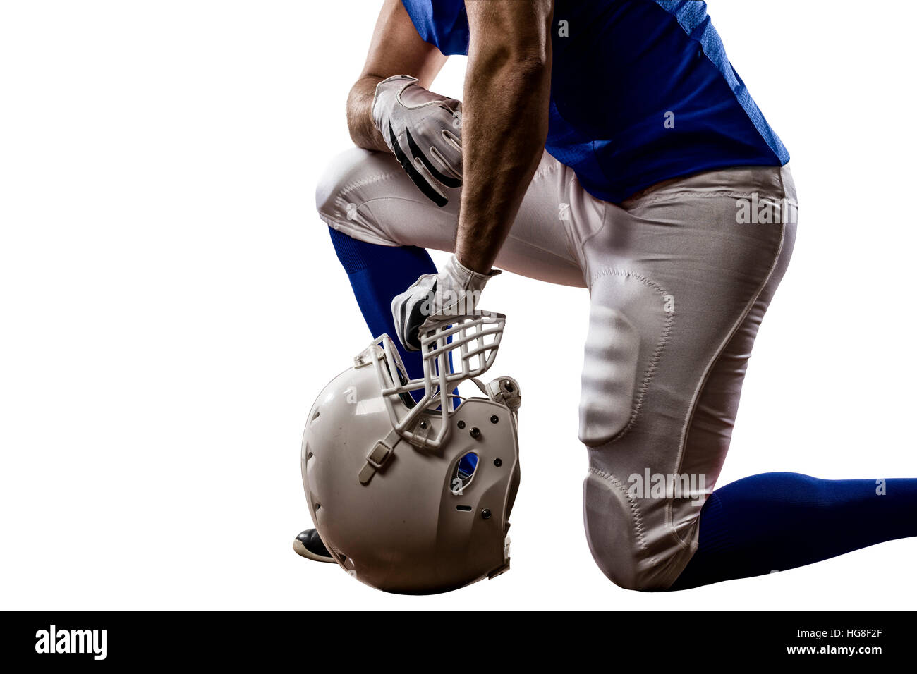 Football Player with a blue uniform on his knees, on a white background