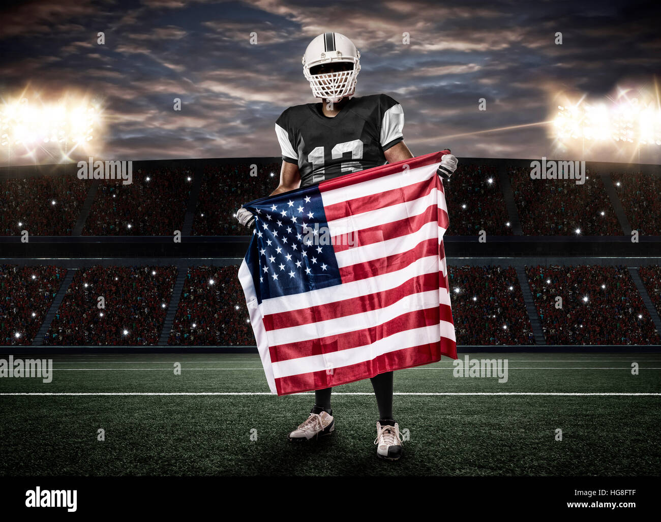 Football Player with a Black uniform and a american flag, on a stadium. Stock Photo