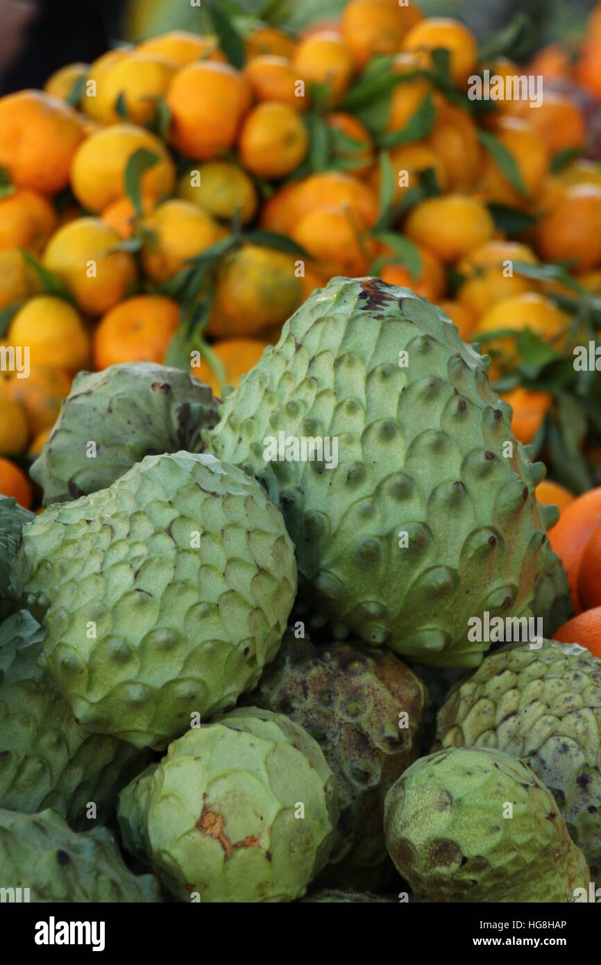 oranges and cherimoya fruit at market Stock Photo