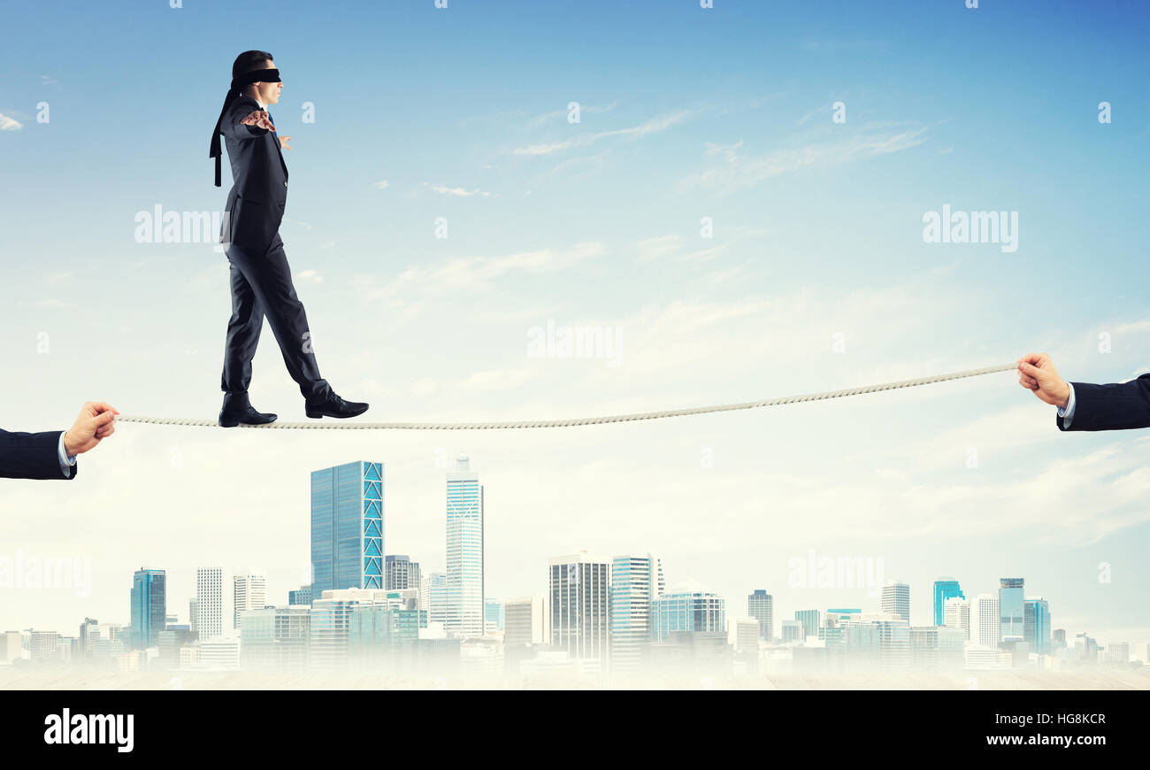 Business concept of risk support and assistance with man balancing on ...