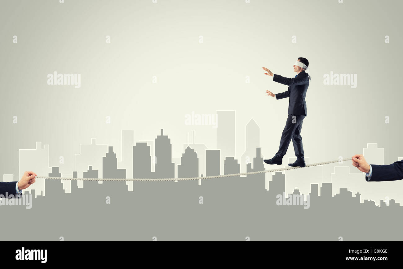 Business concept of risk support and assistance with man balancing on ...