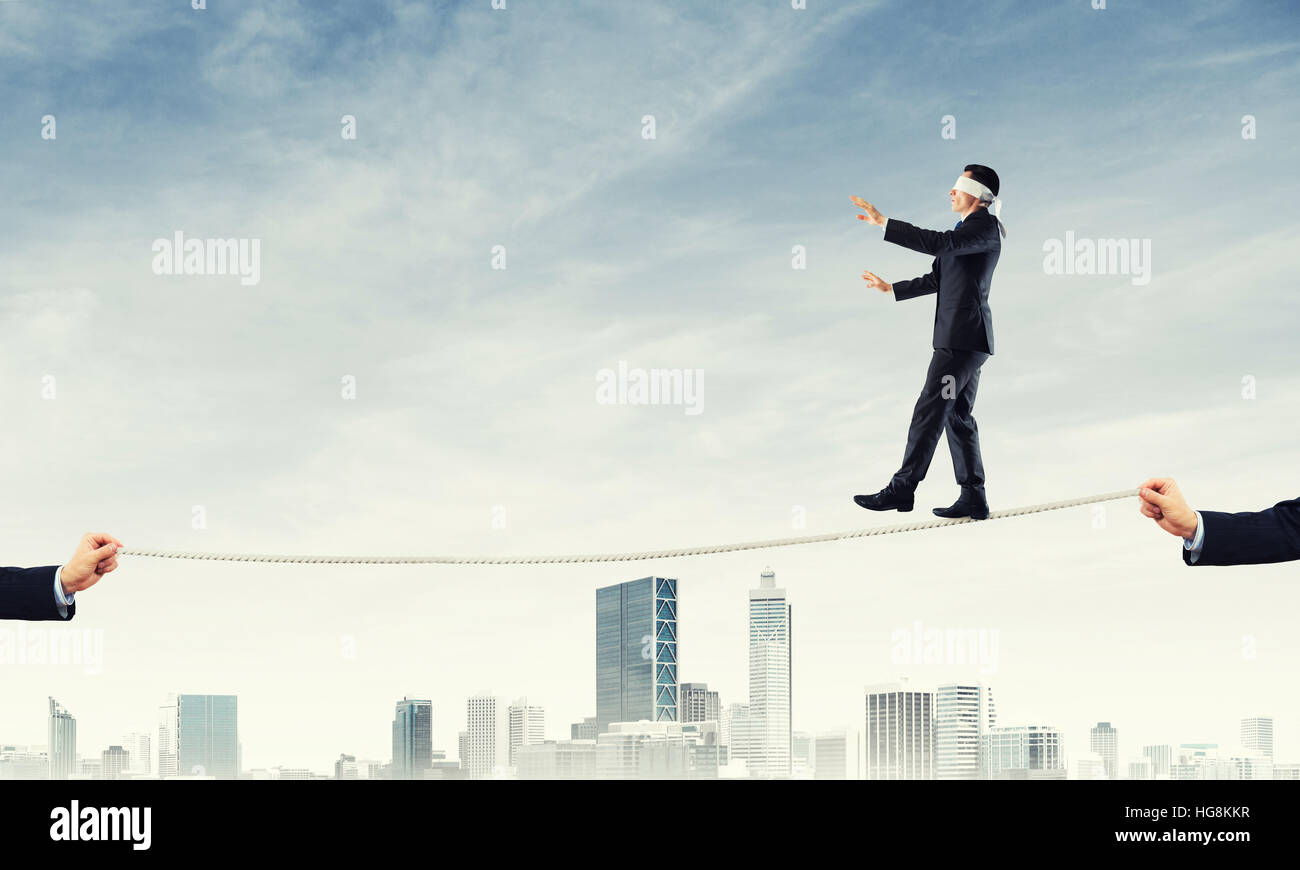 Business concept of risk support and assistance with man balancing on ...