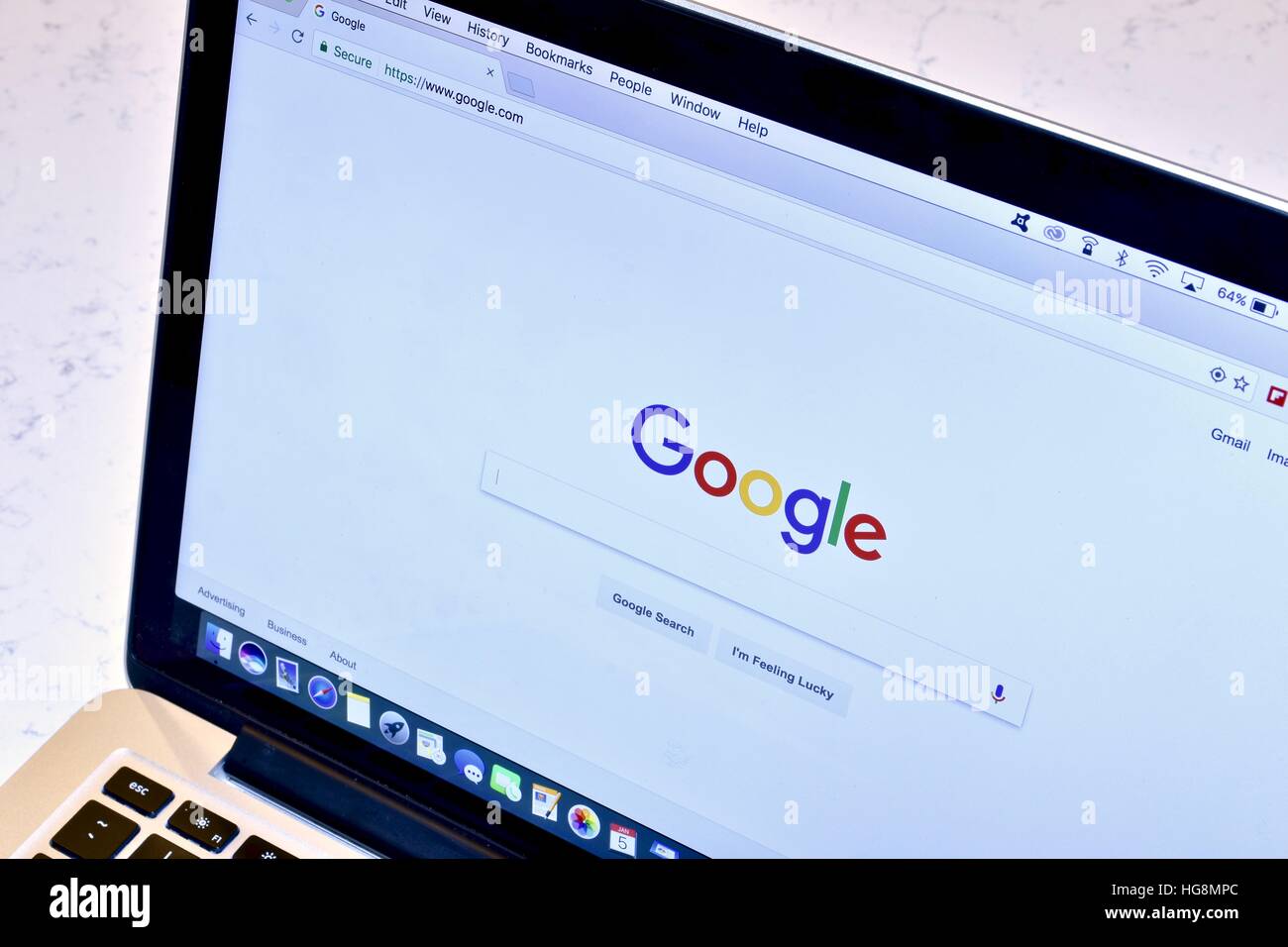 An Apple Macbook Pro with the Google search engine displayed on the screen Stock Photo