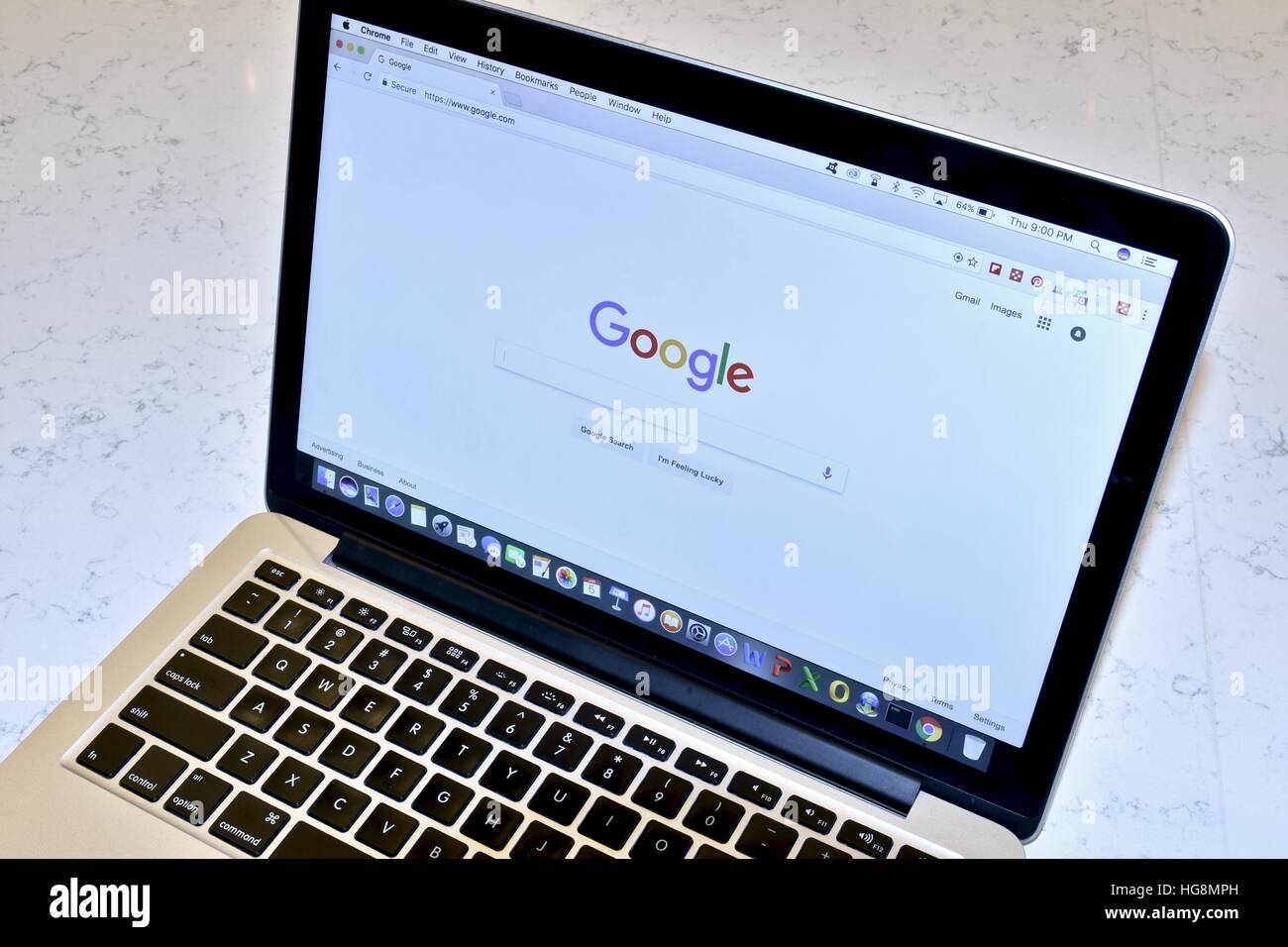 An Apple Macbook Pro with the Google search engine displayed on the screen Stock Photo