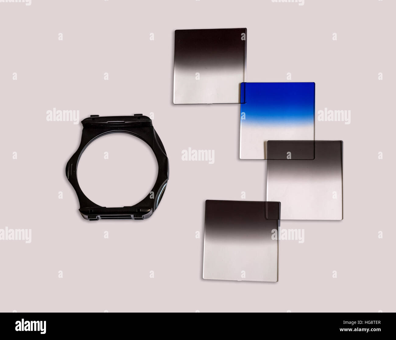 Graduated Neutral density camera filters with holder used for photography isolated in off white background. Stock Photo
