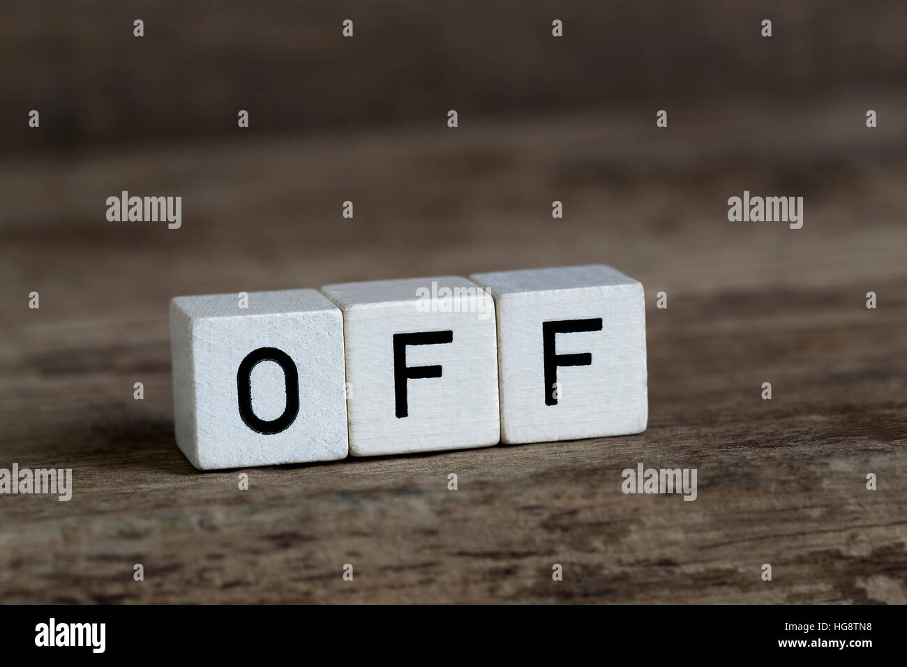Off, written in cubes on wooden background Stock Photo