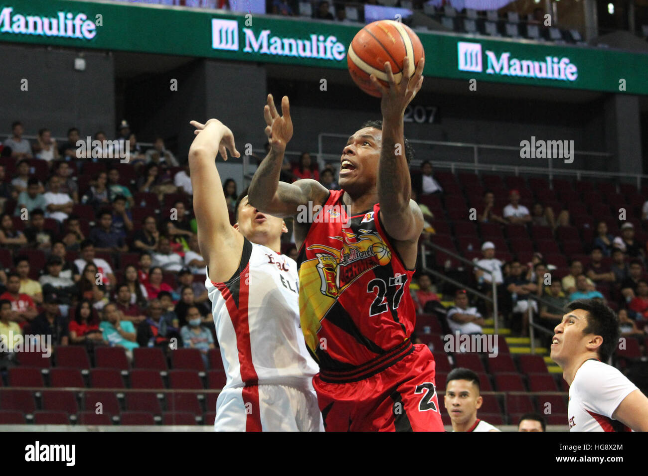 Pasay City, Philippines. 06th Jan, 2017. Gabby Espinas of San Miguel makes a lay-up over a defender from Blackwater. © Dennis Jerome Acosta/Pacific Press/Alamy Live News Stock Photo