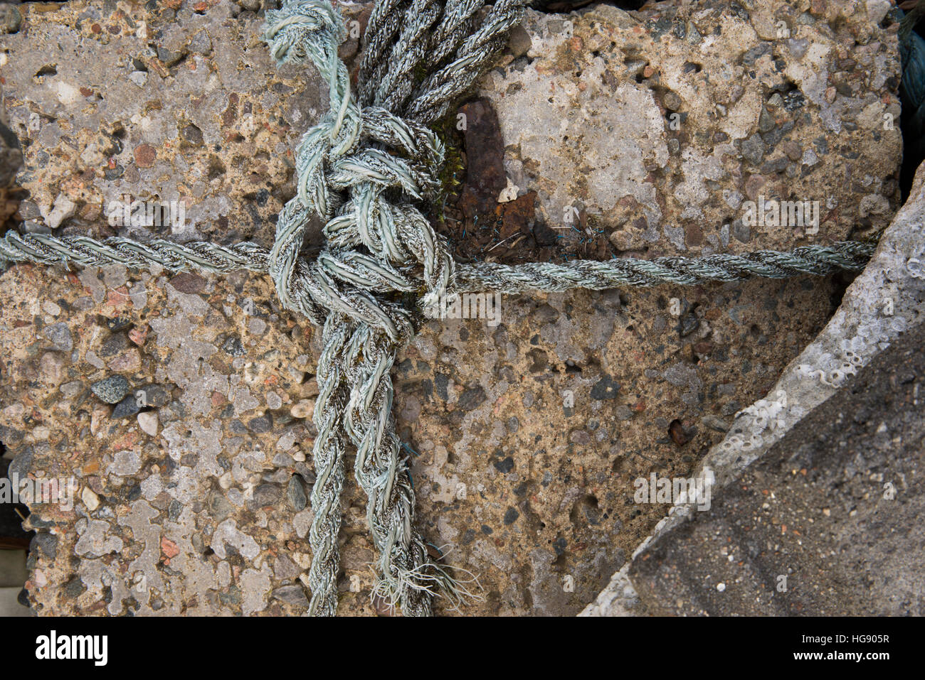 A rope bound rock holding down a roof on a building at Uisken, Isle of ...
