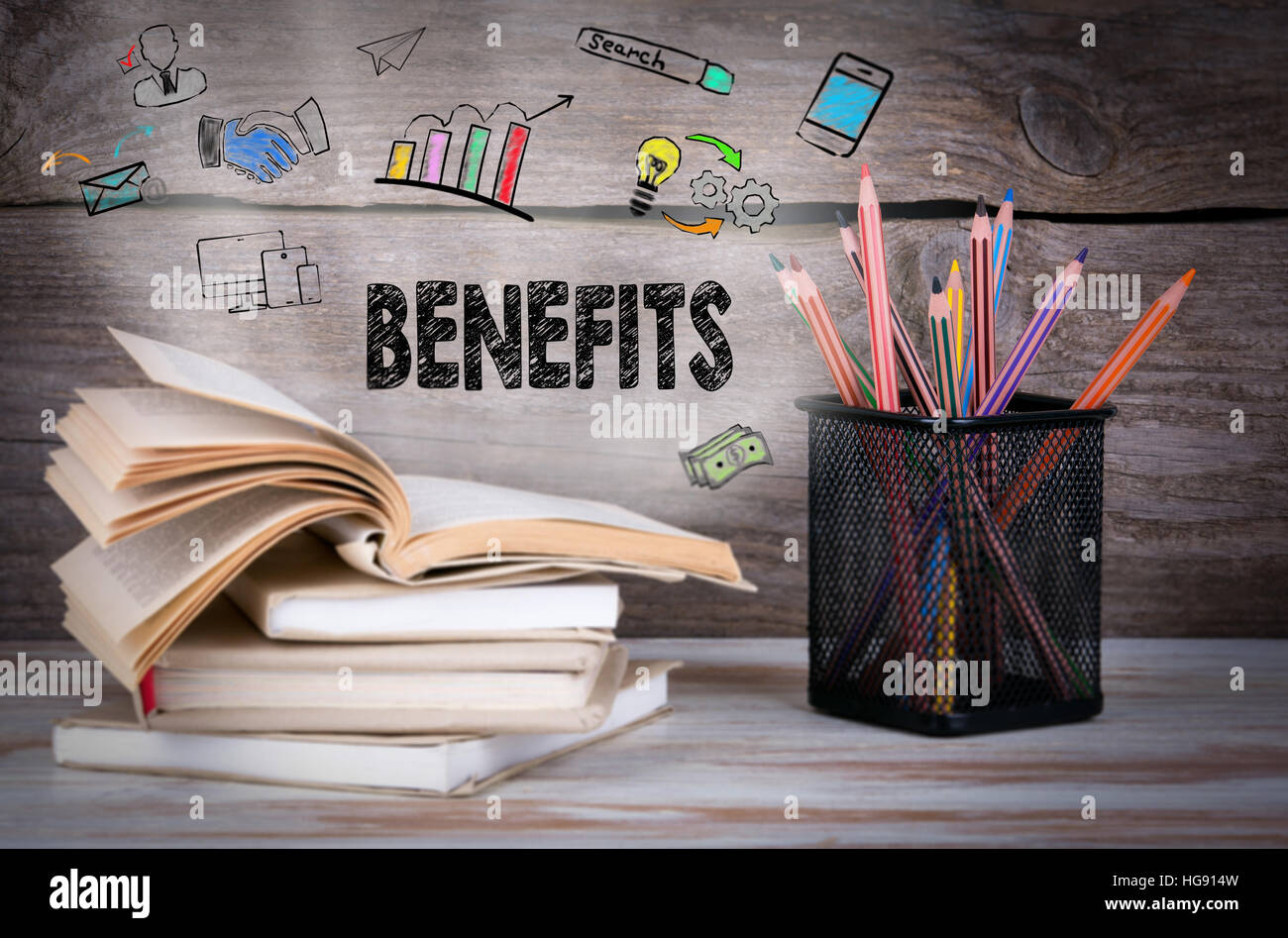 Benefits, Business Concept. Stack of books and pencils on the wooden