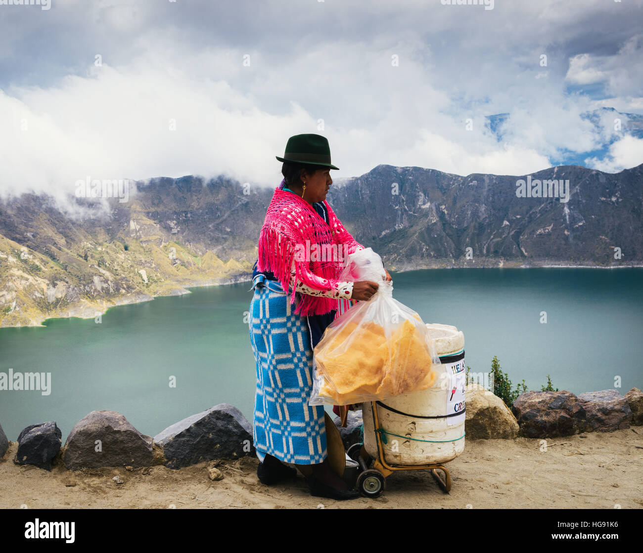 Andean indigenous woman selling textiles in traditional Inca customs in Quilotoa volcano, Ecuador Stock Photo