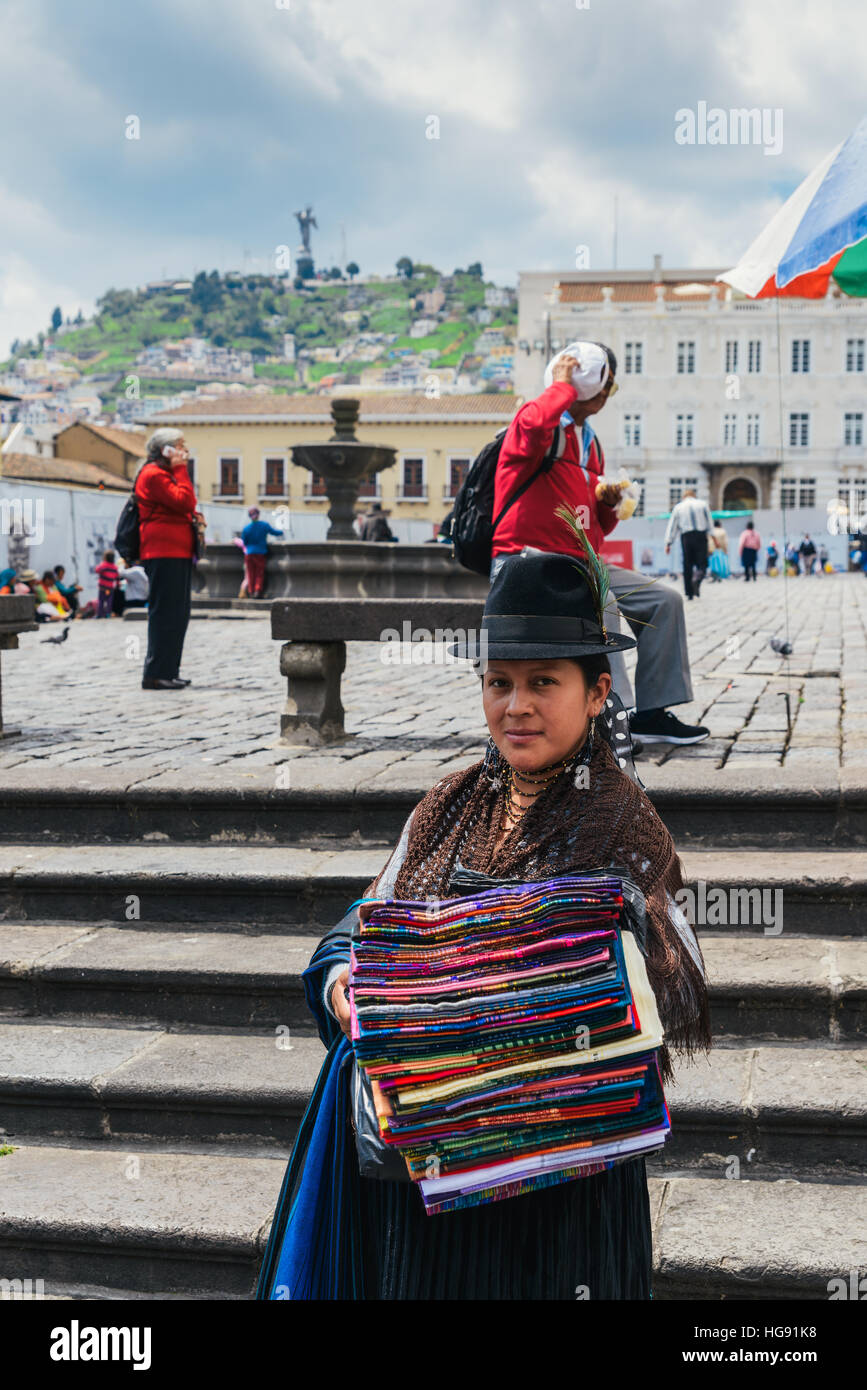 Andean indigenous woman selling textiles in traditional Inca customs in Quito, Ecuador Stock Photo