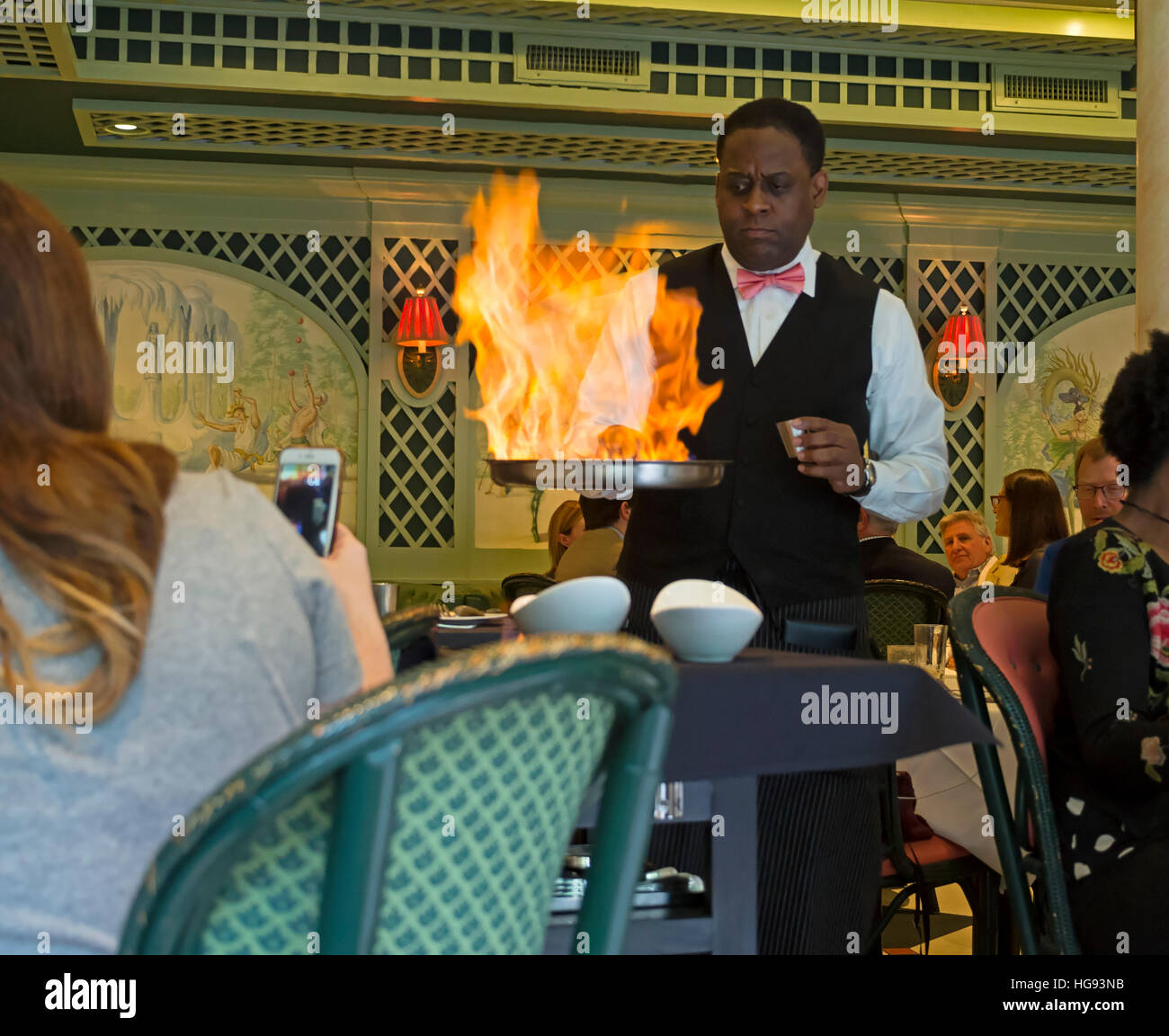 A waiter prepares Bananas Foster at Brennans Restaurant in New Orleans