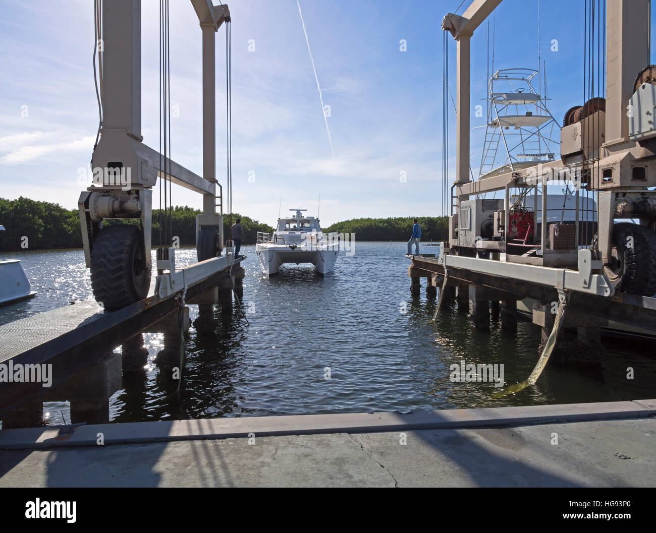 An Endeavour Trawlercat approaches a boat lifting sling hoist for haulout Stock Photo