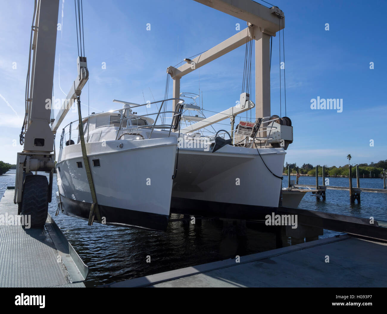 An Endeavour Trawlercat being lifted out of the water in a boat lifting