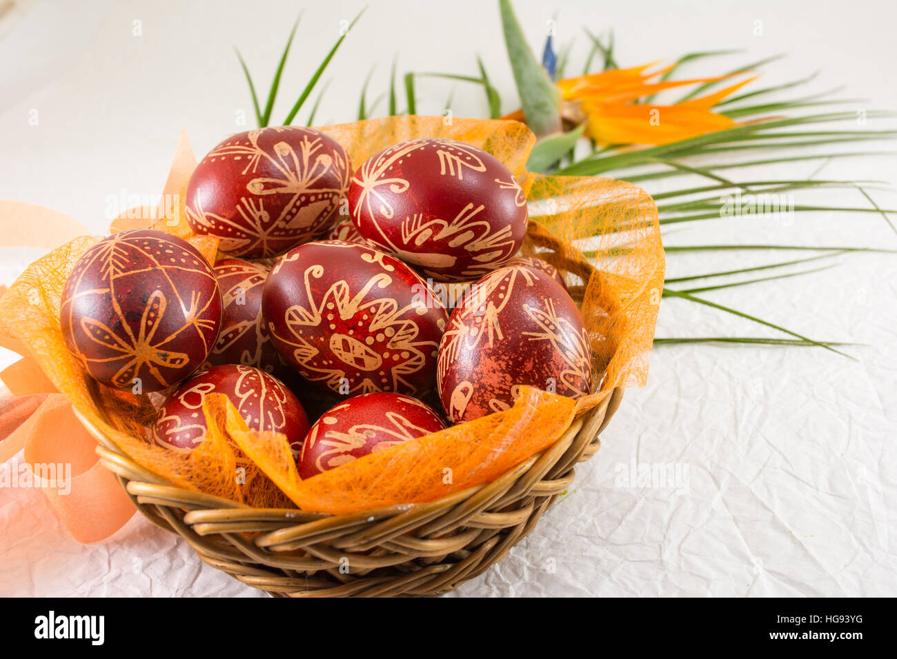 Easter eggs decorated with wax and orange flower Stock Photo