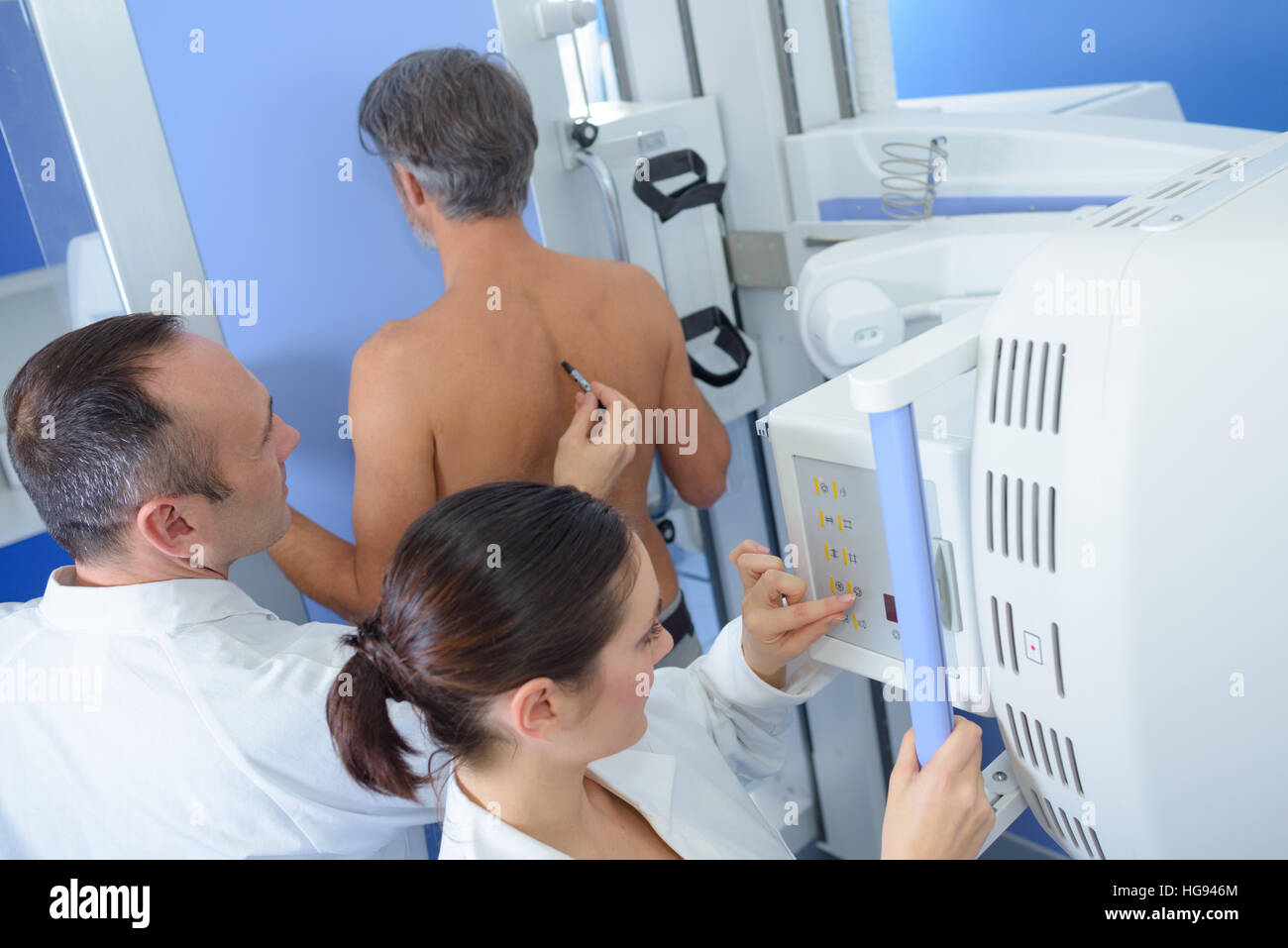 Doctor marking patient's back for medical procedure Stock Photo