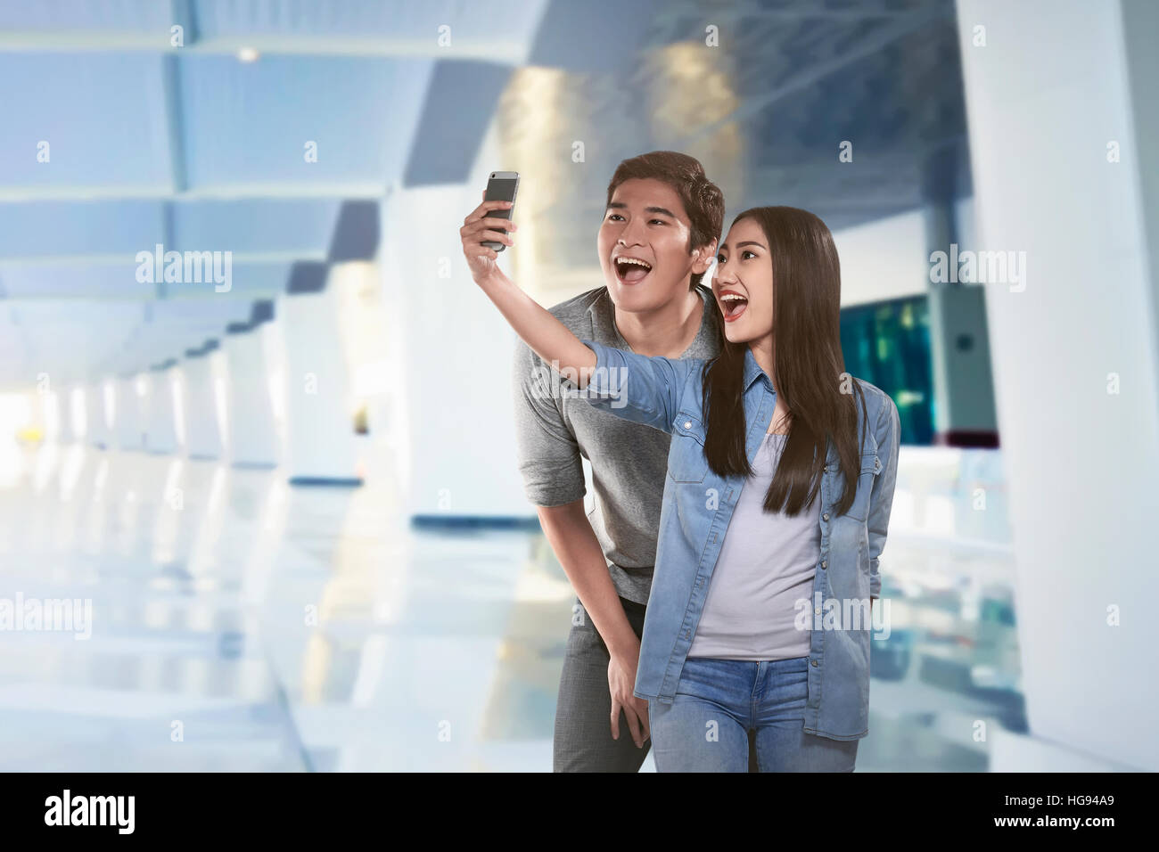 Young asian couple taking selfie by smartphone in the inside room Stock ...