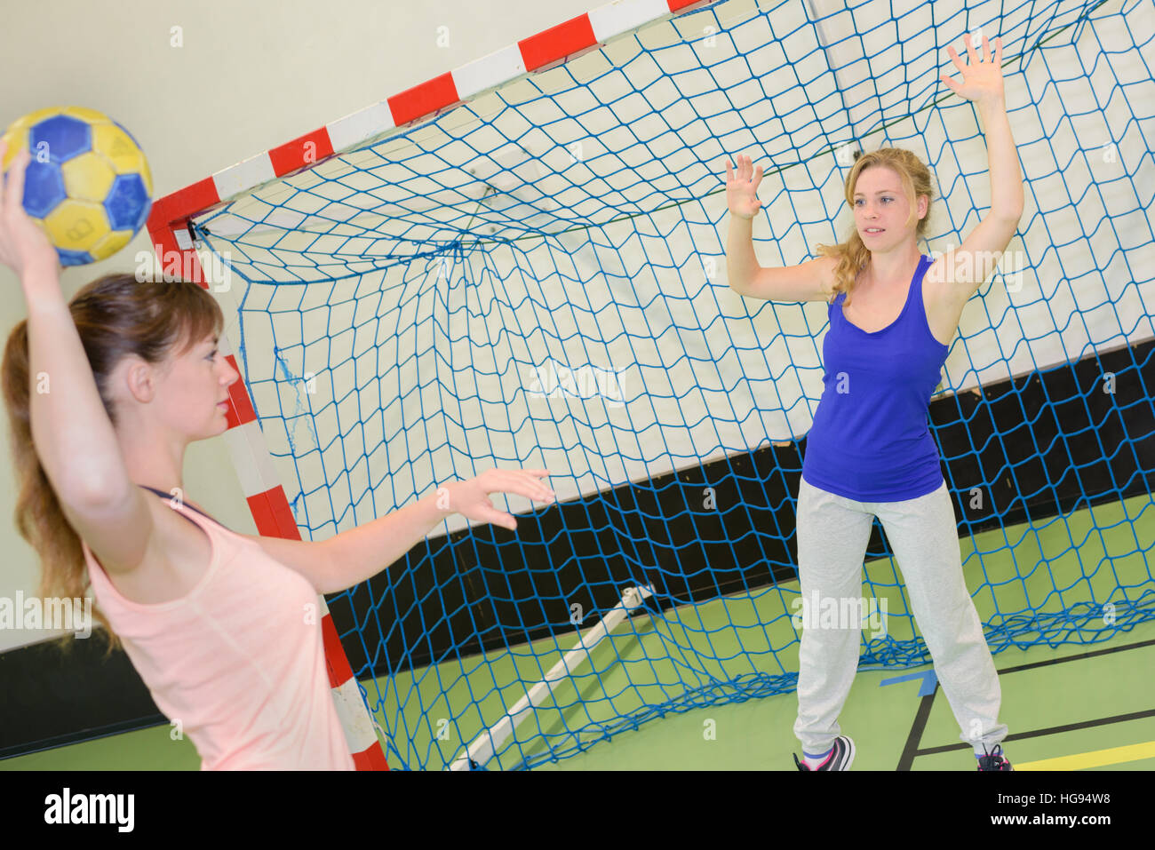 Woman defending handball goal Stock Photo