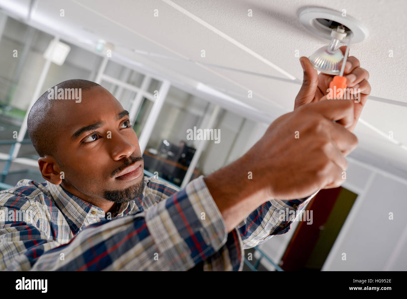 Man fitting spotlight using screwdriver Stock Photo Alamy