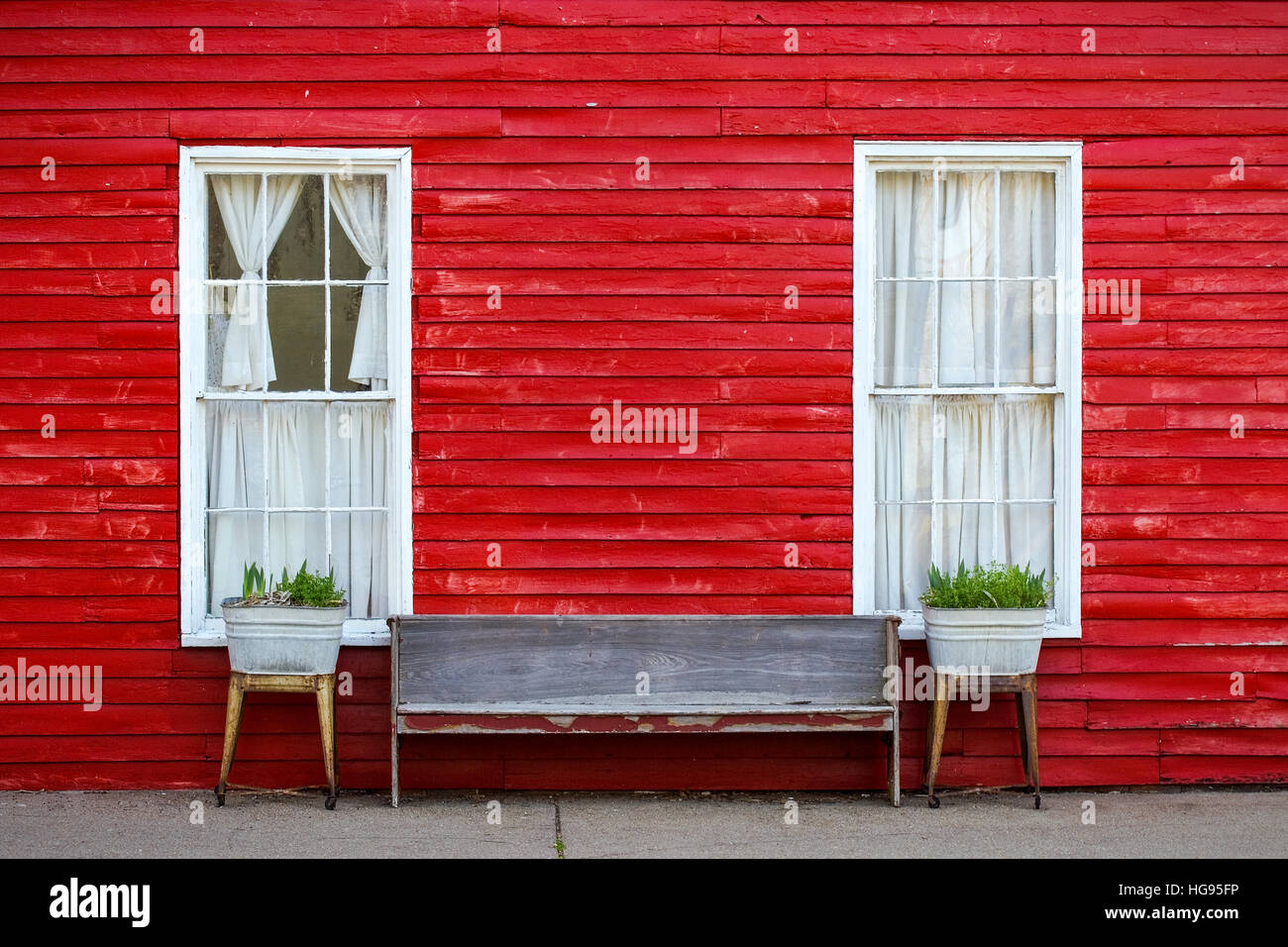 Red exterior clapboard wall with two symmetrical windows Stock Photo Alamy