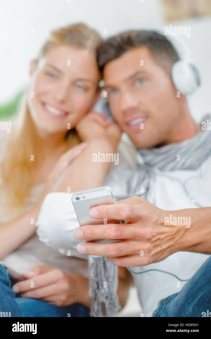 Couple sharing headphones Stock Photo Alamy