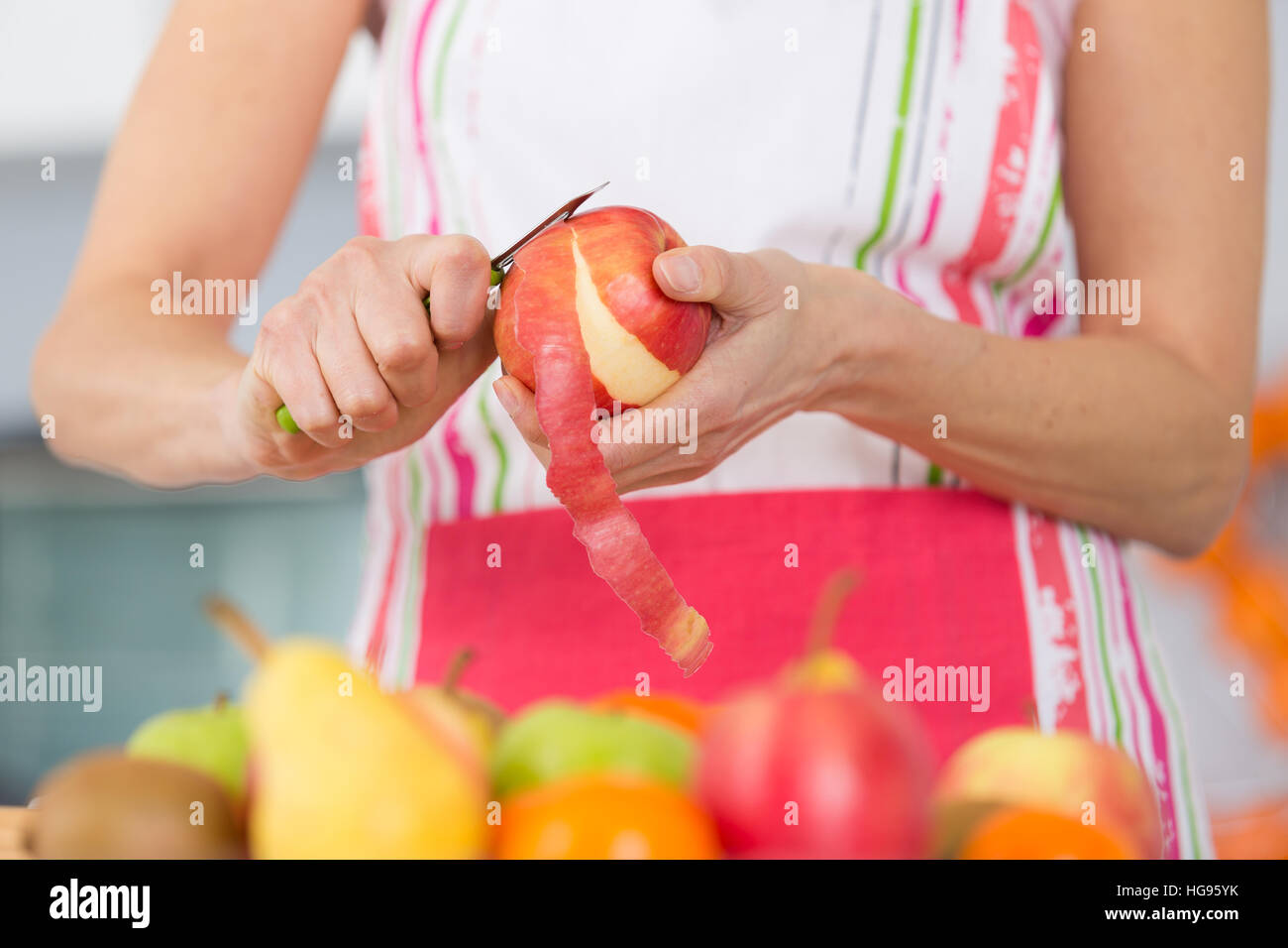 elder woman peeling apples in her kitchen Stock Photo - Alamy