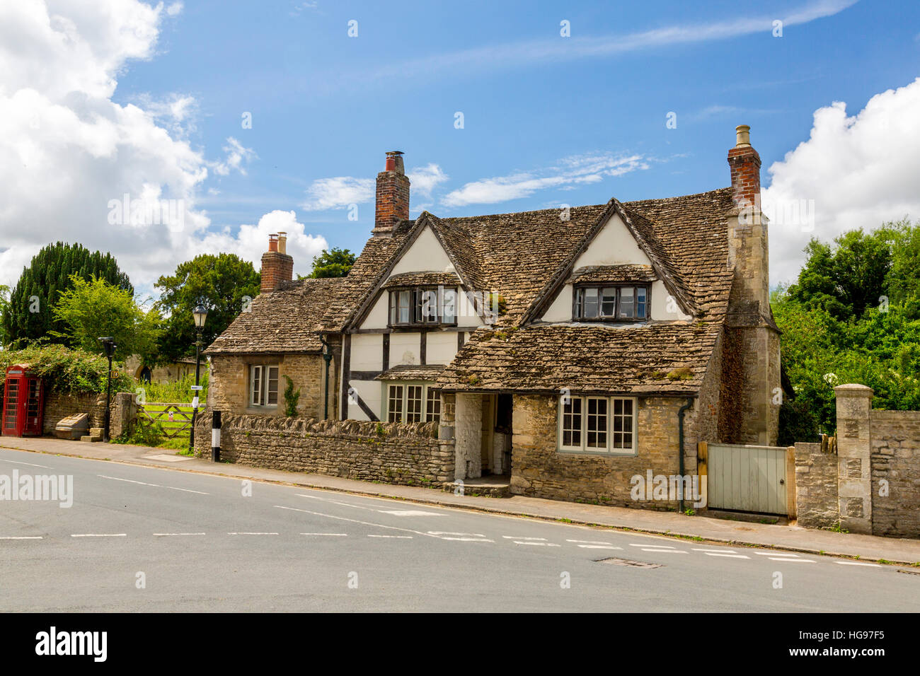 A half-timbered and stone built cottage with stone roof tiles in the village of Lacock, Wiltshire, England, UK Stock Photo