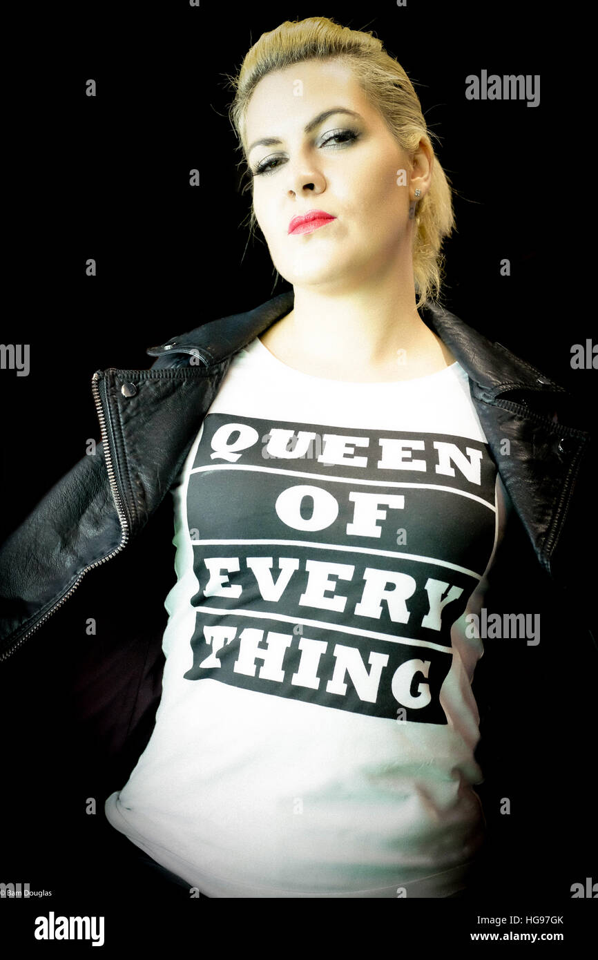 Blonde, biker chick model poses in 'Queen of Everything' motto t-shirt Stock Photo