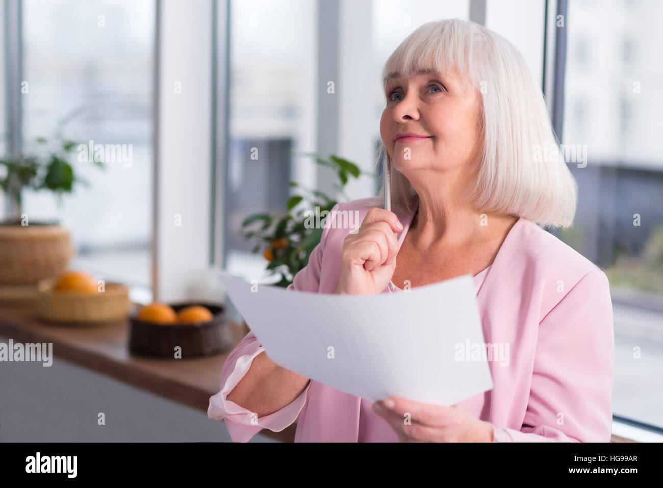 Mature woman thinking pen hi-res stock photography and images - Alamy