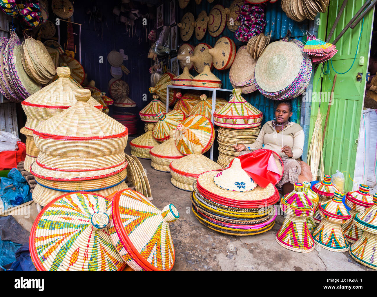 Ethiopian woman makes Habesha baskets for sale on a local market in