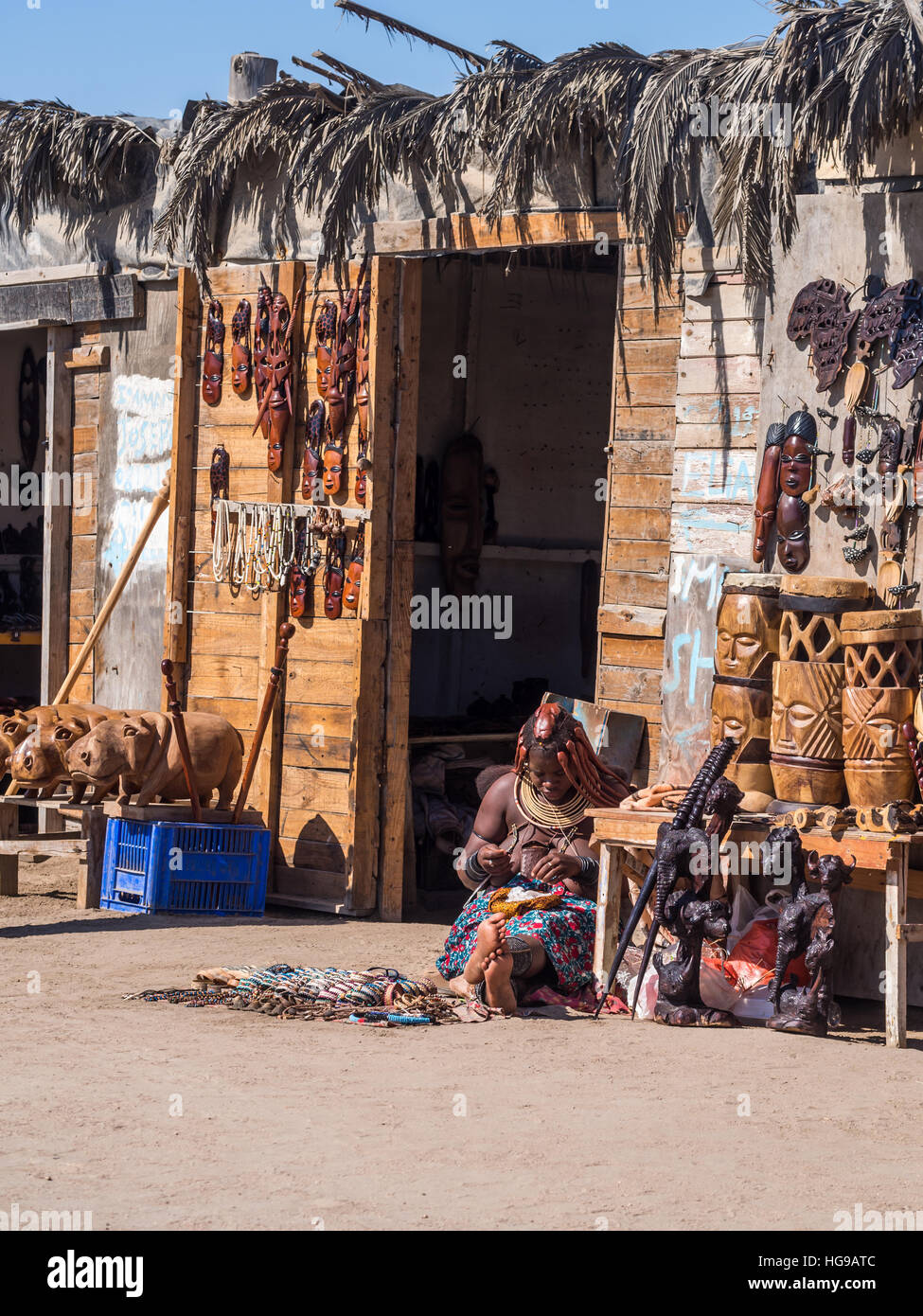 Himba woman sells souvenirs in Walvis Bay, Namibia. Stock Photo